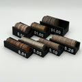 A set of six black plastic coin stacks and denominations labels from $.01 to $.1.00, shown on a light gray background.